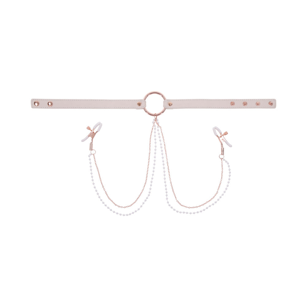 The Peaches 'n Cream Collar and Nipple Clamps by Sportsheets features a white adjustable collar with a central metal ring and rose gold hardware. Two chains decorated with small white beads extend to clips on either end, resembling nipple clamps. The collar's size can be adjusted using multiple snap buttons, providing an elegant and delicate design.