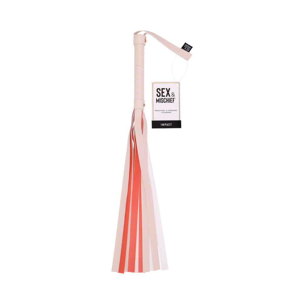 With its vibrant design, the Sportsheets Peaches 'n Cream Flogger features a white handle and pink gradient faux leather tassels. A "Sex & Mischief" tag adds a playful touch near the handle.