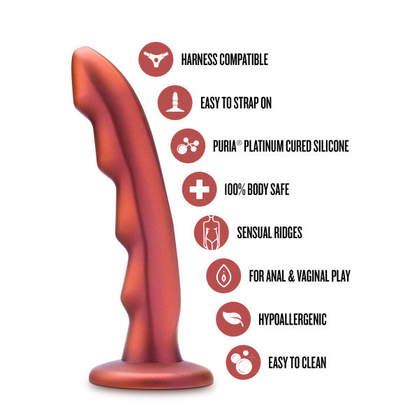 The Jealousy 7 Inch Rippled Silicone Dildo by Blush is shown. It features a wavy, textured design and harness compatibility for easy strap-on use, crafted from Puria® platinum cured silicone. This dildo is made from body-safe materials and has sensual ridges specifically designed for prostate stimulation. It is suitable for both anal and vaginal play, hypoallergenic, and easy to clean.