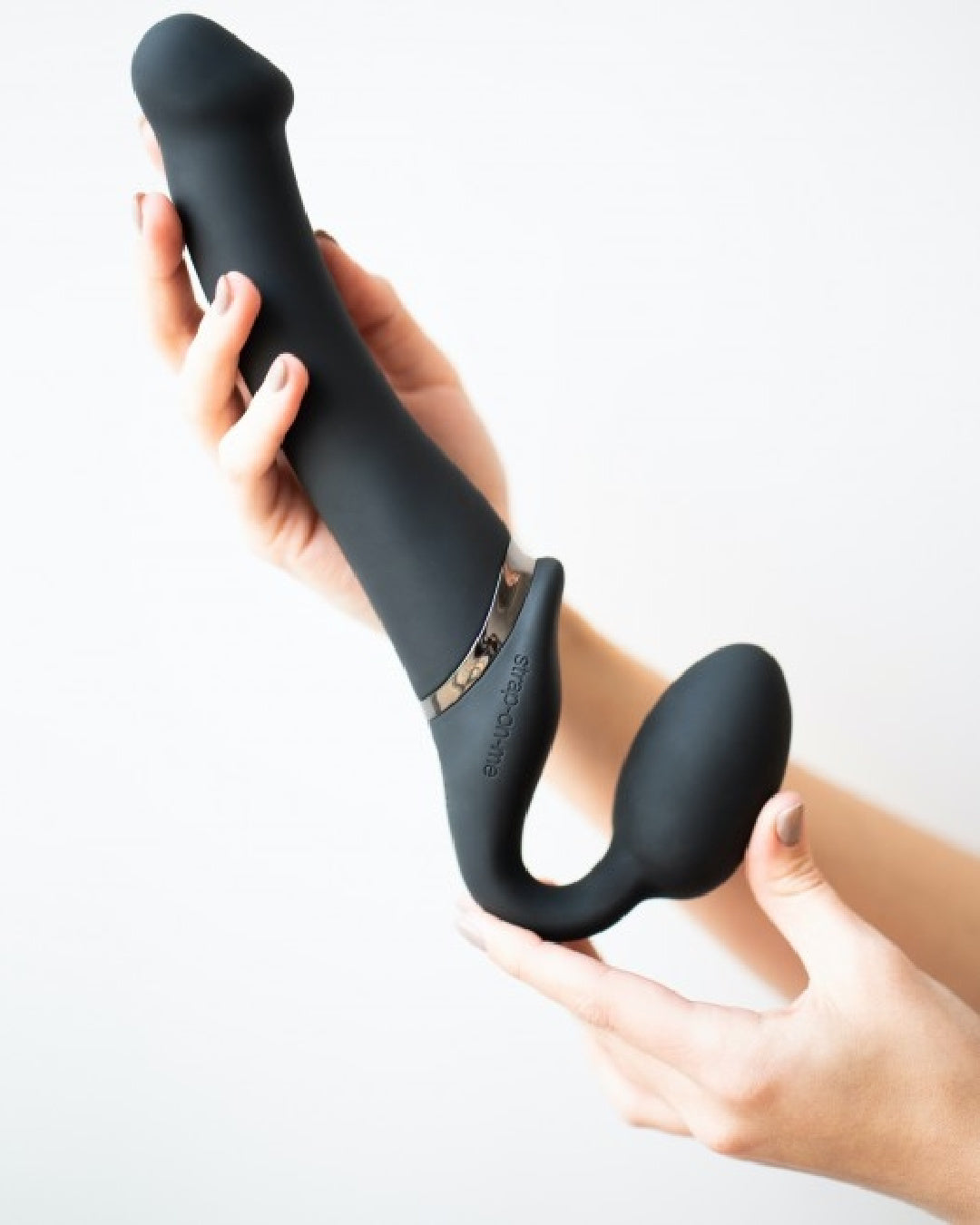 Lovely Planet Vibrating Strapless Strap On Black- Large held on angle in model's hand
