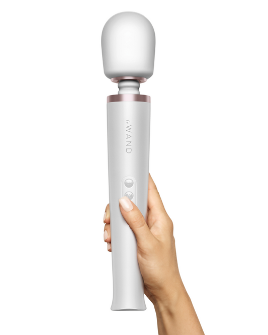 Le Wand Cordless Vibrating Massager - White held in a person's hand to show the size