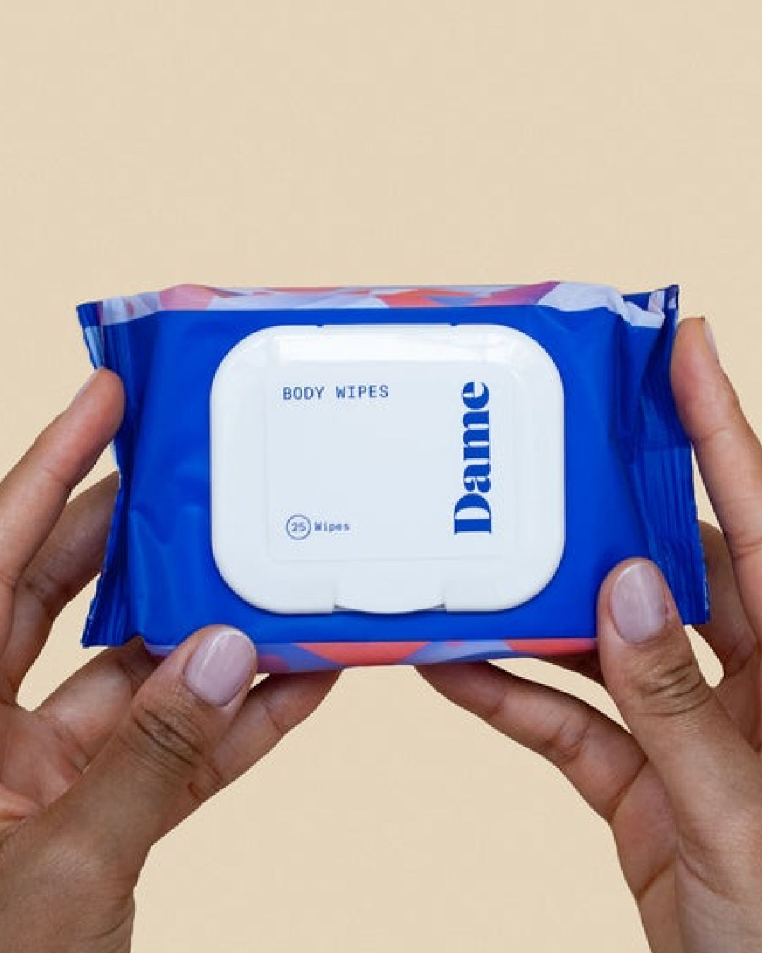 Dame Aloe Infused Body Wipes package held in model's hand