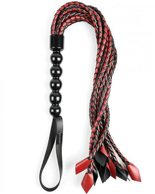 Saffron Braided Flogger by Sportsheets looped on its side with a white background