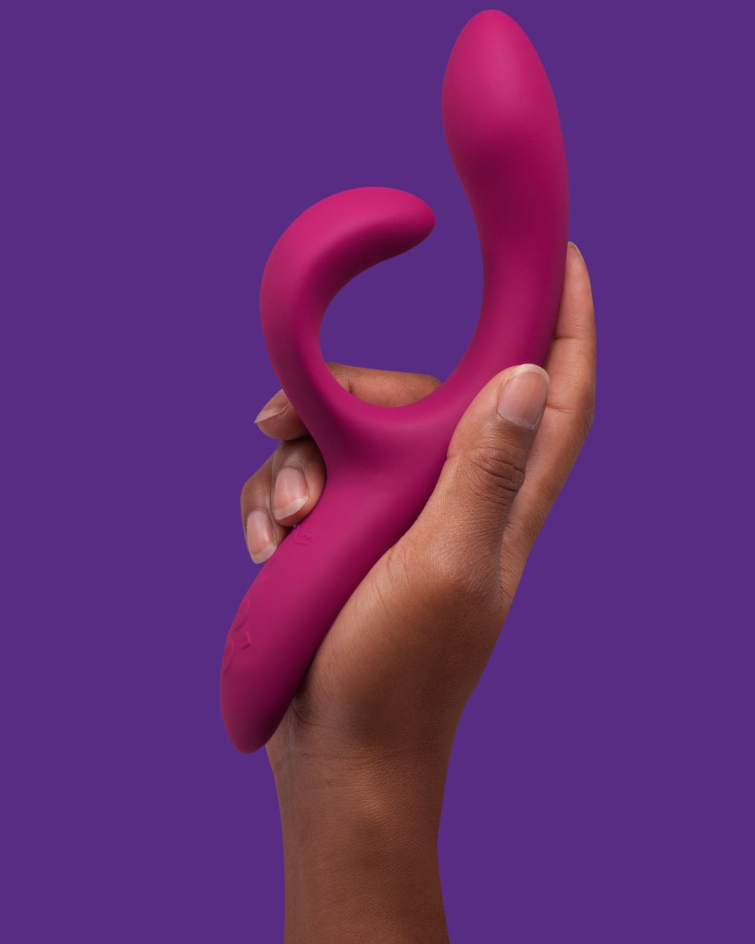 We-Vibe Nova 2 Rechargeable Dual Stimulator Vibrator on purple background in model's hand