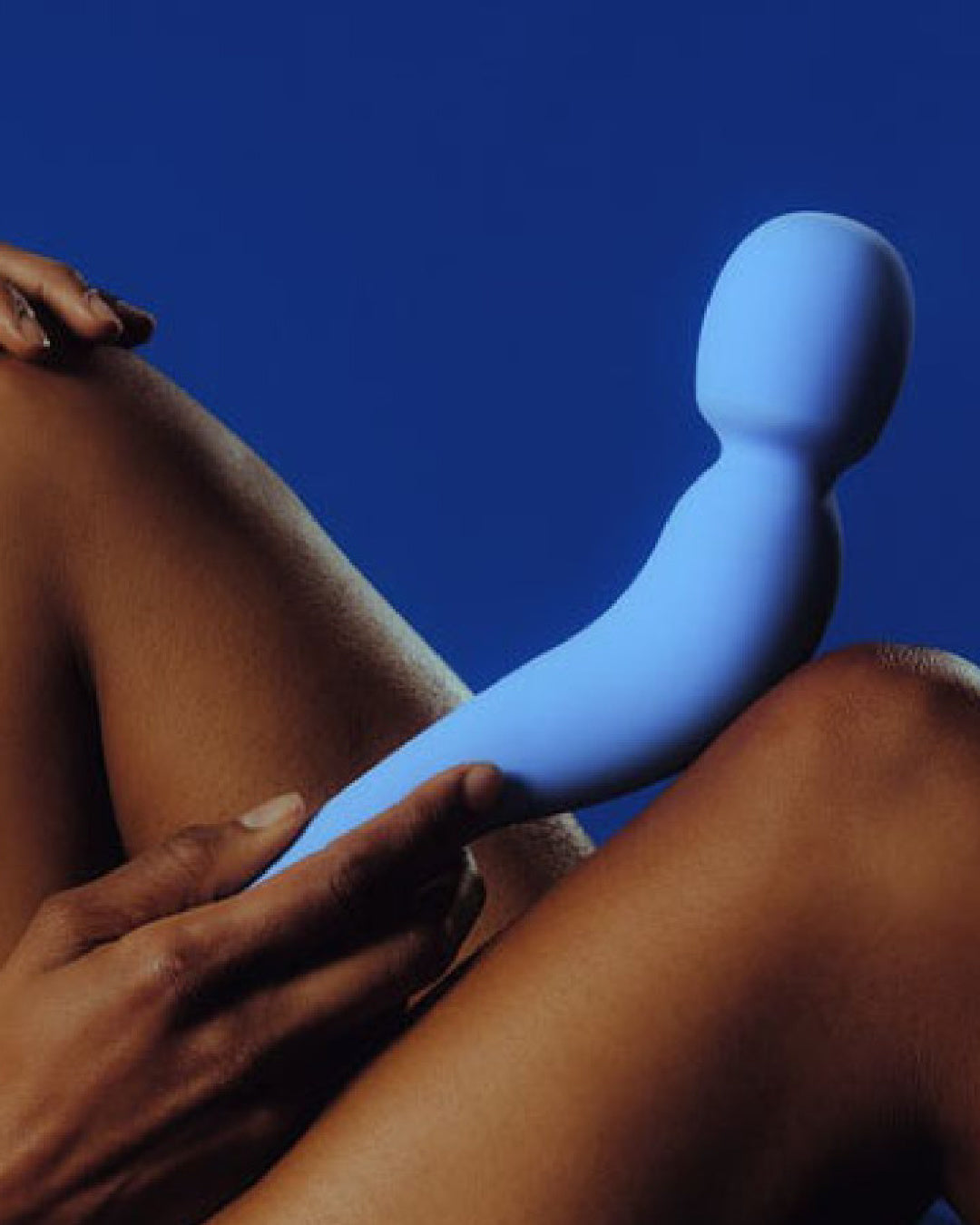 Dame Com Wand Vibrator - Periwinkle laying on model's leg