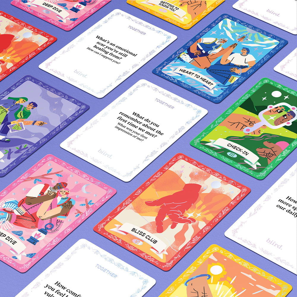 The Together Couples Intimacy Card Game features colorful cards with text prompts and vibrant illustrations of diverse people, arranged diagonally on a purple surface to encourage connection and fun for couples.