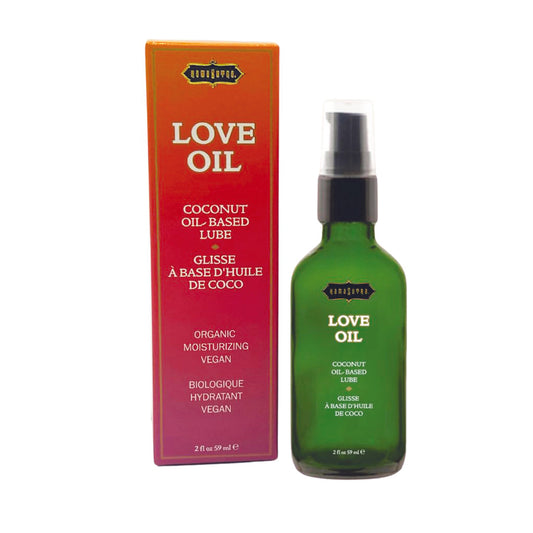 A green bottle of "Love Oil Coconut Oil Based Lubricant & Body Glide" from Kama Sutra, celebrated as a coconut oil lubricant with a pump top, is placed next to its vibrant red and orange box. This organic lubricant is vegan and promises a moisturizing glide. Both the bottle and the box prominently feature the product name.