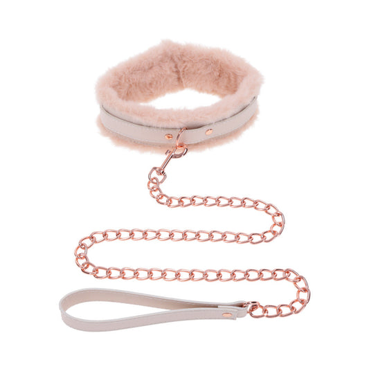 The Peaches 'n Cream Fur Collar and Leash by Sportsheets features a fluffy pink collar with a rose gold chain and matching leather handle, perfect as an accessory for pets or for gentle bondage during intimate moments.