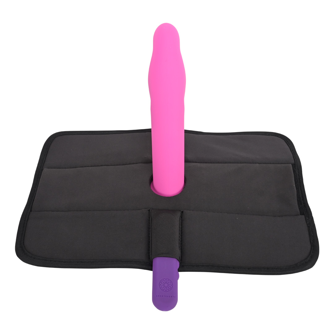 A pink Pivot 3 in 1 Play Pad Toy Mount standing upright on a black foldable mat against a white background, designed for pivot positioning as a hands-free sex toy.