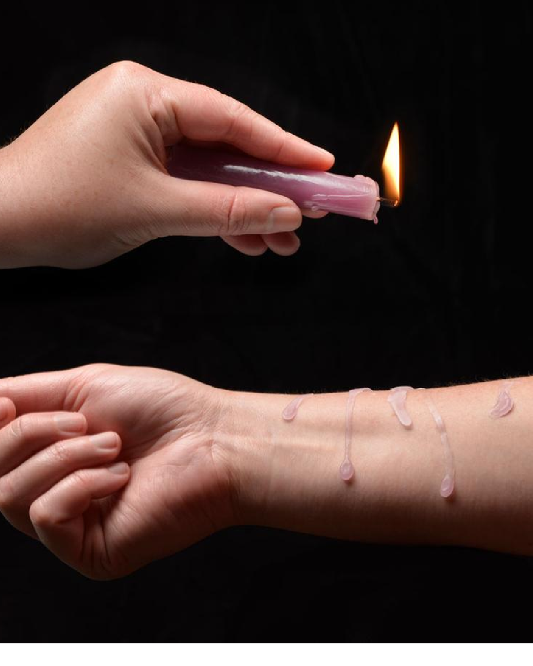 Lacire Drip Pillar Candles - Violet candle being dripped on model's arm 