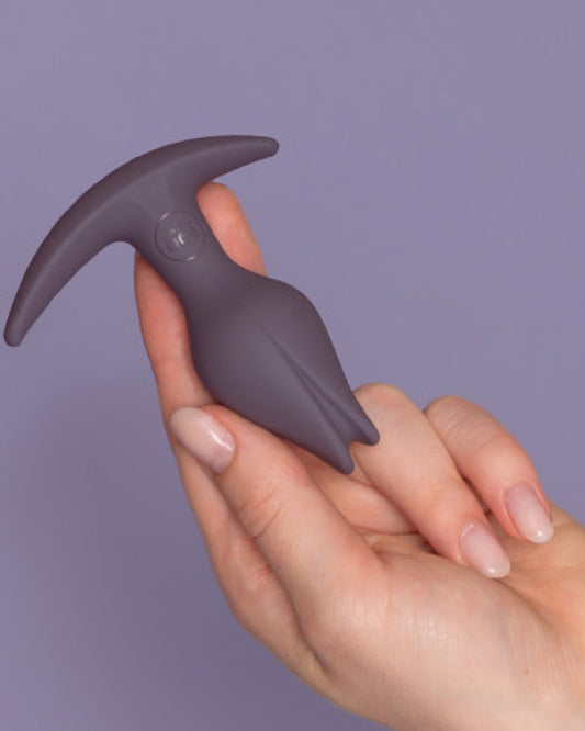 Fun Factory Bootie Fem Anal Plug - Purple upside down in hand 