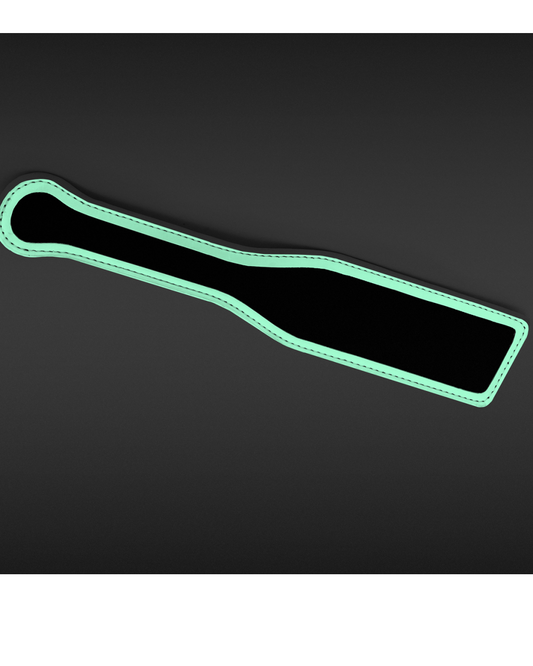 Black paddle glowing in the dark on black background 