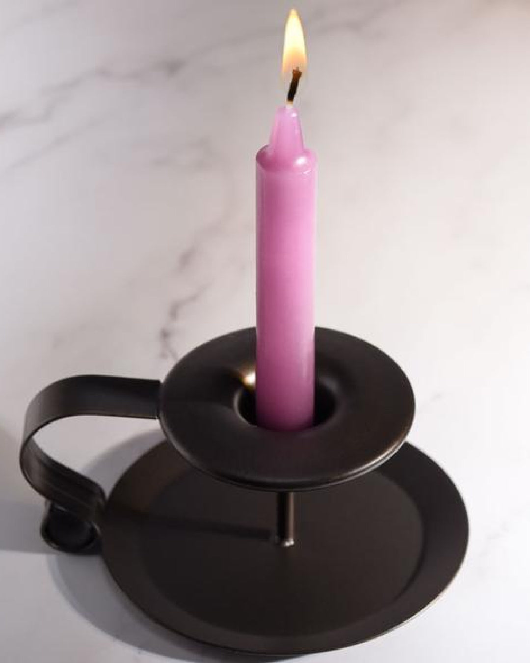 Lacire Drip Pillar Candles - Violet lit candle in black candle holder 